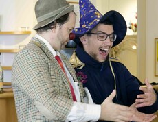 Clown mit roter Nase und junger Mann mit Zauberhut