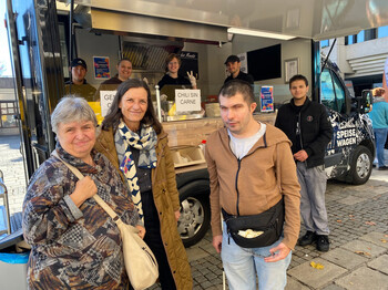 Drei Personen vor dem Speisewagen