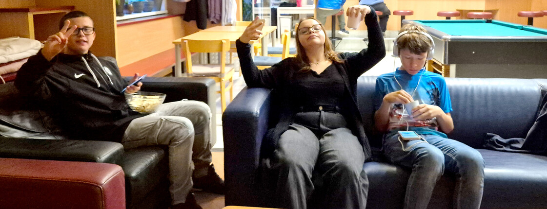 Drei Jugendliche sitzen auf einer Couch im Jugendtreff.